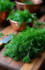 Fototapeta premium Fresh green dill herb lies on wooden board with knife. Copper bowls hold more dill plants. Ready for cooking or seasoning food. Ingredient for healthy meals.