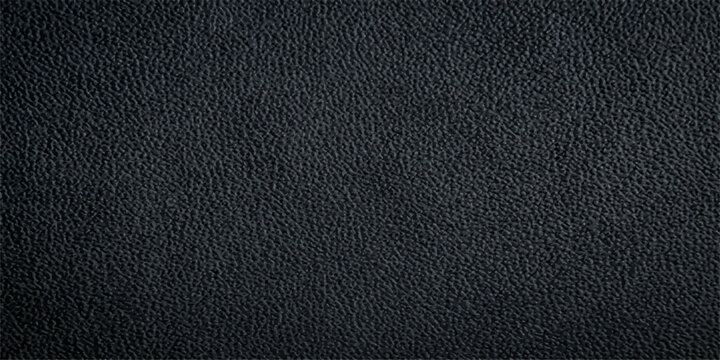Close-up texture of dark, genuine leather, showcasing its natural grain and subtle sheen, perfect for background or design elements.