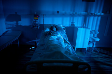 Medical environment with careful nurse and monitoring devices present. Patient is currently being supervised carefully in hospital setup with vigilant staff and monitoring tools © fotodrobik