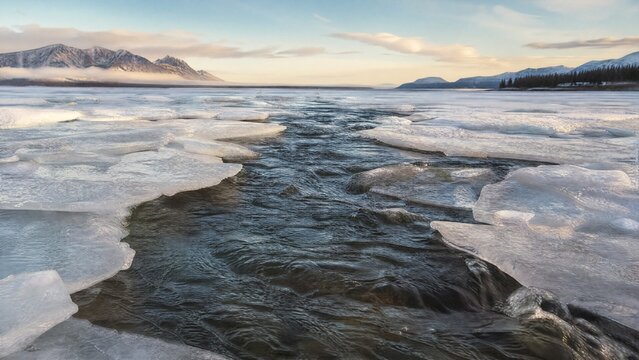verglas. Landscape of a melting river breaking through ice in morning light. travel magazines, destination branding, designed for outdoor magazines and nature guides, drives exploration.
