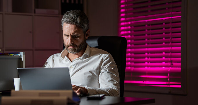 Bored exhausted manager using laptop having tight deadline. Exhausted employee. Business man exhausted on late office work. Overworked bored employee. Copy space banner