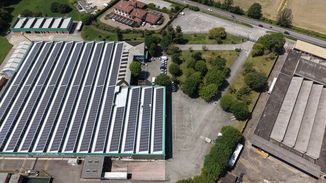 Solar-Powered Industrial Park: An expansive industrial park showcases rows of solar panels adorning the rooftops of large manufacturing buildings.