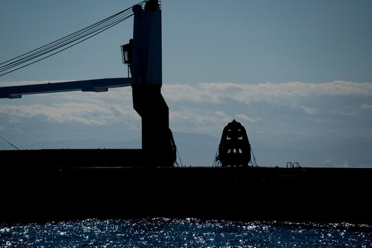 huge dredger on a barge silhouette