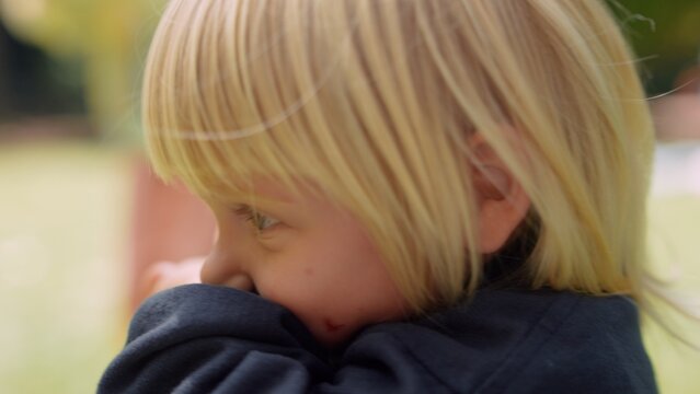 Child covering face. Small kid conceals face with shy demeanor