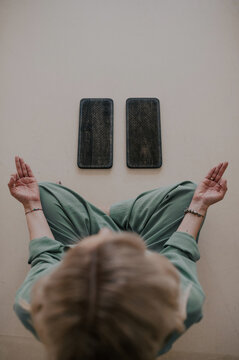 Woman practicing meditation with sadhu boards indoors, mindfulness and spiritual wellness ritual, calm self-development practice with nail standing boards in minimalist interior