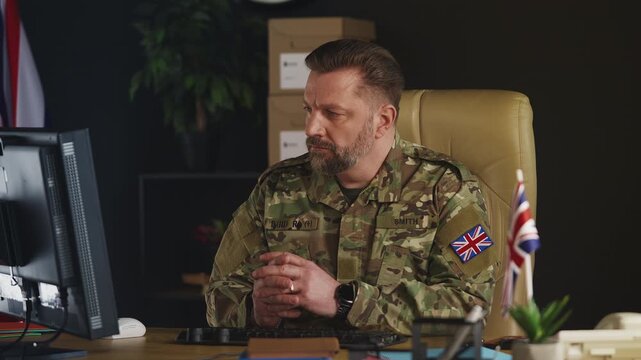 British army officer working on computer, planning military operations