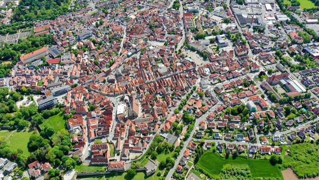Aerial view of the historic old town with its traditional red-tiled rooftops, charming streets, and lush green parks under bright sunlight in Forchheim, Bavaria, Germany.