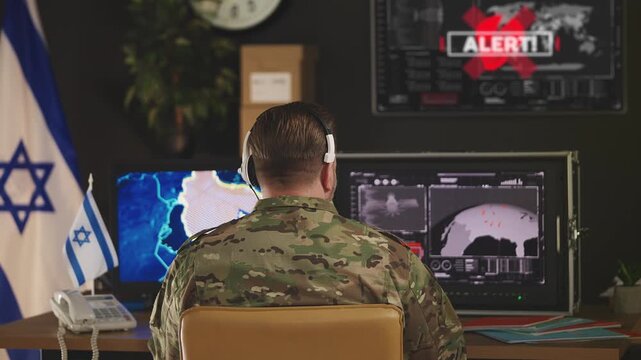 Israeli army officer detecting air raid alert during military mission monitoring