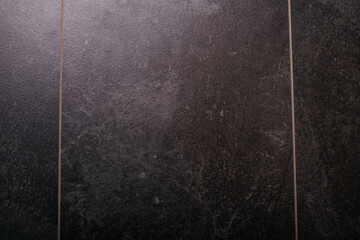 Fototapeta premium Dark textured wall surface with vertical panels and grunge pattern