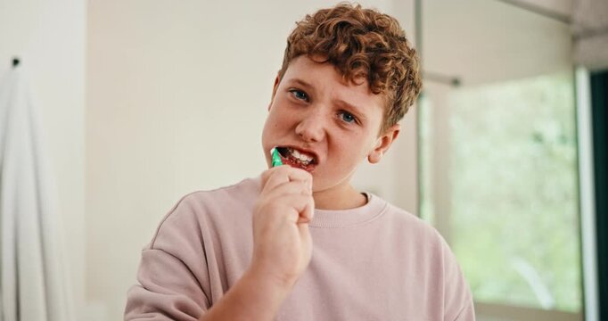 Bathroom, face and boy with toothbrush, brushing teeth and cavity prevention with toothpaste in home. Clean, mouth and child with dental care equipment for fresh breath, portrait and oral hygiene