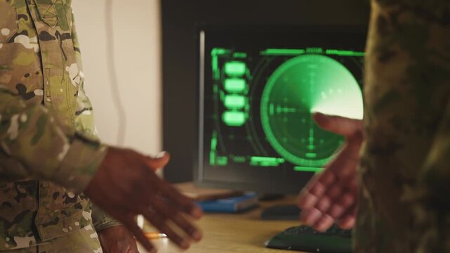 Military officers shaking hands after successful negotiations in command center