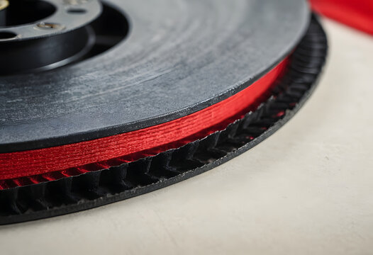 Red electrical wire spool closeup for energy and connection