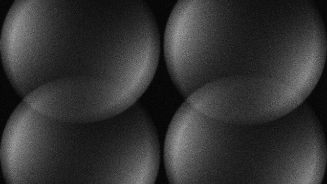 Four smooth spheres glow softly against a dark void. Subtle highlights trace each curve with quiet elegance. Texture hints at velvet or polished stone beneath surface. Minimalist design evokes calm