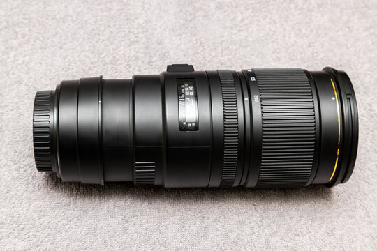 Professional Telephoto Zoom Camera Lens on Gray Surface