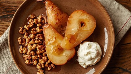 Fototapeta premium Close-up aerial view of grilled sweet pears with walnuts and honey. Caramelized vegetarian autumn dish. Tasty snack. Sliced fruit on a ceramic plate atop a wooden table.
