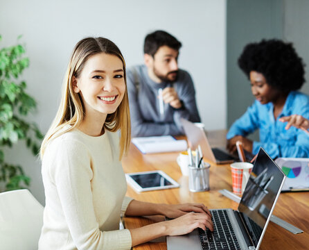 Portrait of a group of young business people having a meeting in the office. Teamwork and success concept, portrait of a smart young businesswoman