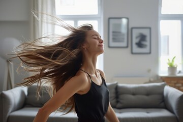 Naklejka premium Woman dancing in iving room couch head hair.