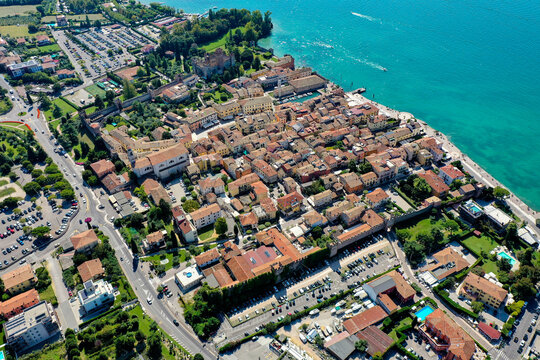 Aerial view of the historic town of Lazise with its medieval walls and red-tiled rooftops along the shores of Lake Garda Provincia di Verona, Veneto, Italy.