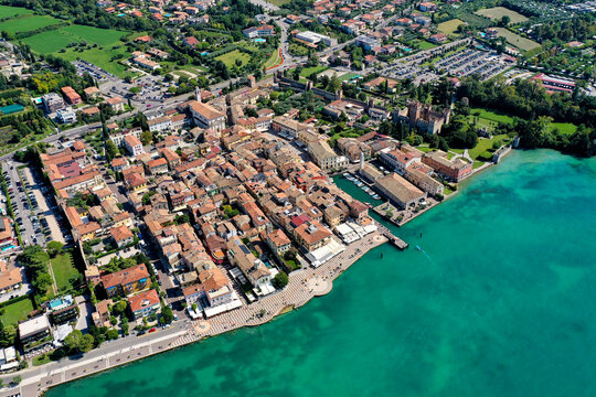 Aerial view of Lazise town with its historic harbor and medieval walls along the turquoise shores of Lake Garda Provincia di Verona, Veneto, Italy.