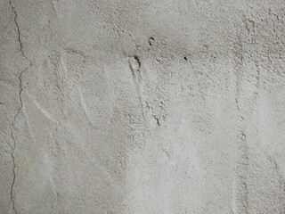 Fototapeta premium Gray concrete wall with rough textured surface. Cement background for construction or industrial design. Solid material detail for architecture, renovation, and home building project.