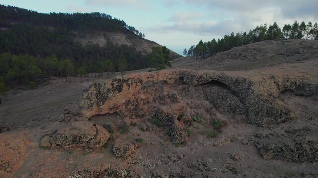 Aerial view orbiting around the Ventana del Nublo, a natural stone arch and geological formation in the mountains of Gran Canaria