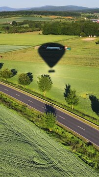 Hot Air Balloon Ride. Aerial view on the field during sunset. Landscape from drone. Agricultural landscape from air.