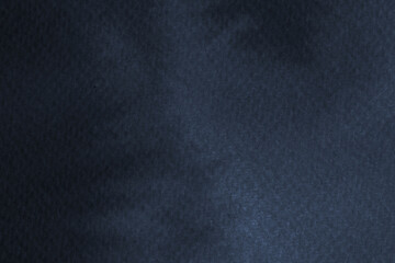 Fototapeta premium Dark blue textured background with a soft, mottled pattern. The background is a deep blue, creating a moody and elegant atmosphere. Simple dark blue textured background with blank space.