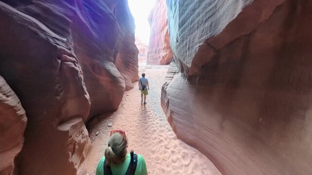 Overhead of Couple Hiking into Canyons in Utah in Buckskin Gulch