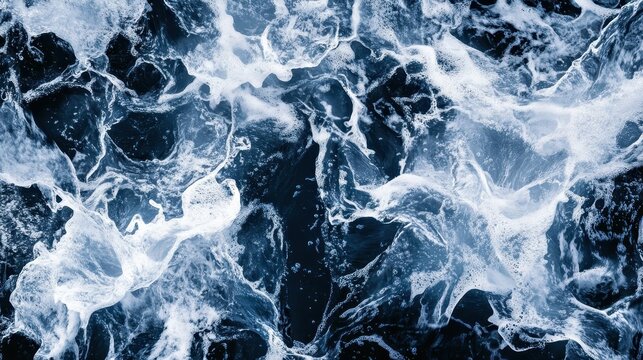 Aerial view of abstract ocean currents with beautiful blue and white swirling textures and patterns