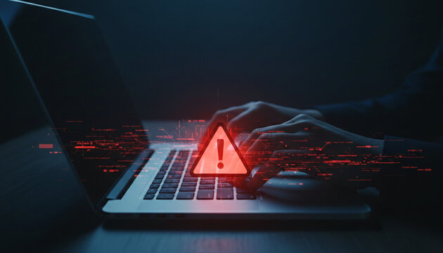 Hands typing on a laptop with a glowing red warning triangle and digital data overlay, symbolizing cyber threat and digital alert, representing security concerns.
