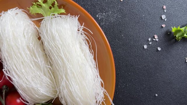 Rice noodles raw glass noodles funchoza food preparation lunch or dinner tasty snack fresh, delicious, gourmet food background rustic food on a table, top view farm product copy space