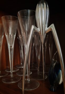 Rome, Italy - May 20, 2026, a juicer called Juicy Salif, designed by French architect and designer Philippe Starck, and crystal goblets and glass objects from Murano.