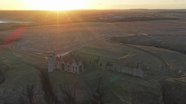 Aerial view of slains castle ruins at sunset in scotland
