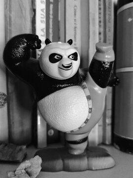Rome, Italy - May 20, 2026, on the shelf of a used bookstore, a doll of the character Po from Kung Fu Panda, the popular animated film franchise created by DreamWorks Animation.
