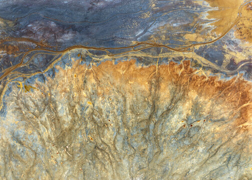 Aerial view of the abstract textures and colorful mineral deposits at the historic mining site Minas de Riotinto, Andalusia, Spain.