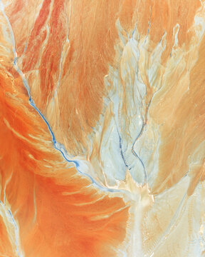 Aerial view of the abstract mineral patterns and vibrant orange sediment at the historic open pit mine Minas de Riotinto, Andalusia, Spain.
