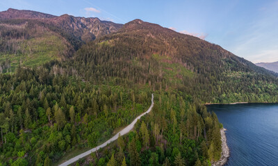 Fototapeta premium Aerial Panorama of Forested Mountains and Harrison Lake Shoreline in British Columbia, Canada