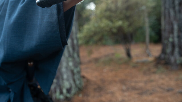 Close-up of a samurai drawing his katana in a forest setting, capturing traditional Japanese swordsmanship and martial discipline. Cinematic scene emphasizing precision, focus, and historical warrior 