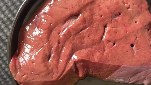 Raw liver offal, meat pork or beef lunch or dinner tasty organic snack fresh, tasty, gourmet food background on the table, rustic food, top view farm product copy space