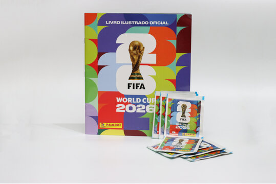 A collection of Panini sticker packets and an album for the FIFA World Cup 2026 tournament, featuring the iconic trophy