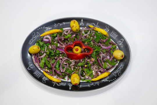 Chicken shish kebab, with delicious onion salad, pickled peppers and olives, and Turkish raki. Photo shoot on a white background.