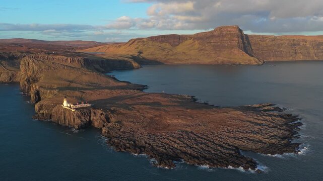 Neist point lighthouse on the isle of skye in scotland at sunset