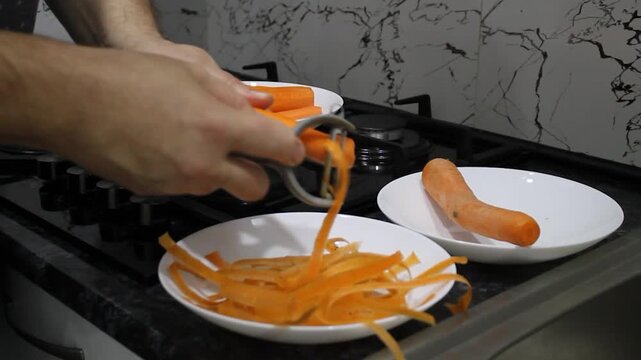 peeling carrots with a vegetable peeler before cooking