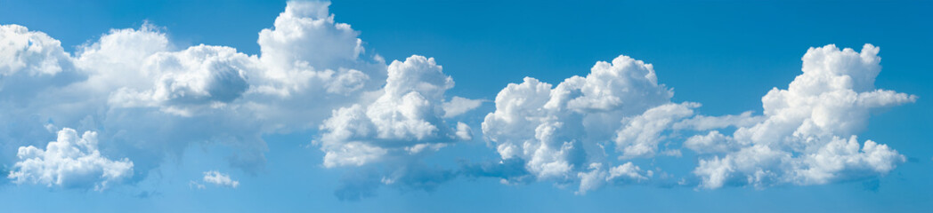 Obraz premium Clouds in a blue sky. Panorama of a group of large clouds during the day