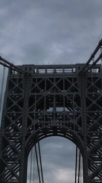 point of view of car driving over george washington bridge between fort lee new jersey and manhattan york heights (sunset night time cloudy suspension bridge)