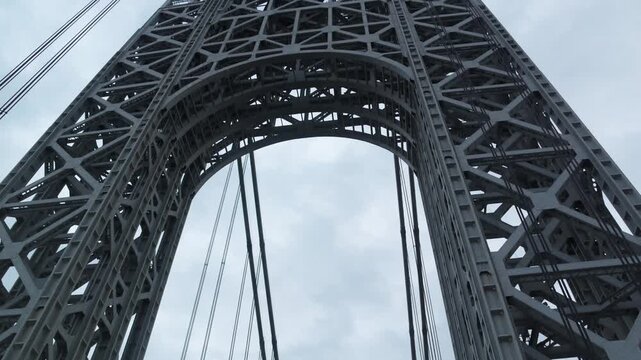 point of view of car driving over george washington bridge between fort lee new jersey and manhattan york heights (sunset night time cloudy suspension bridge)