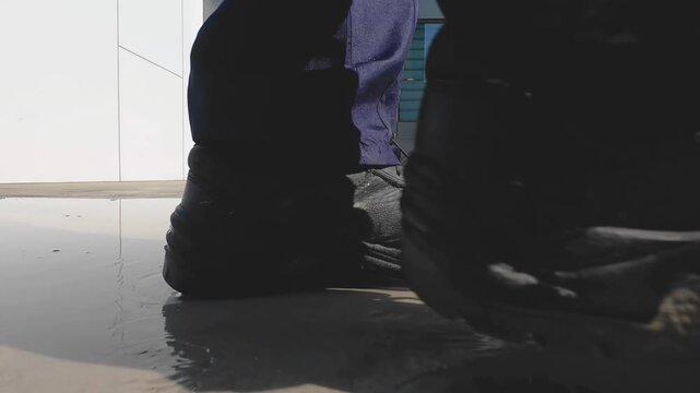 Heavy Work Boots Stepping Through Water in Cinematic Low Angle Close Up