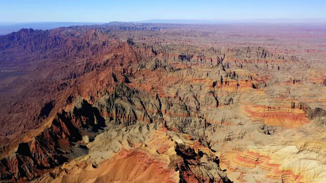 Sprawling Desert Landscape Featuring Layered Rocks And Sharp Ridges Extending Into Distance