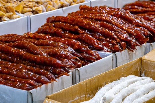 Cevizli sucuk. Traditional Turkish cuisine dessert. Walnut sausage dessert at local market stall in istanbul. Variety of sweets on the arab street market stall. Eastern sweets in a wide range, baklava