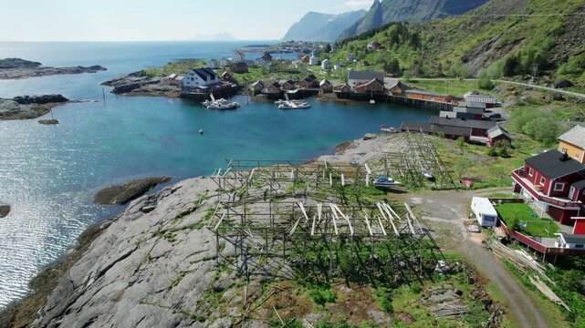 Picturesque aerial view revealing a traditional fishing village in the Lofoten Islands, Norway, with wooden racks for drying fish